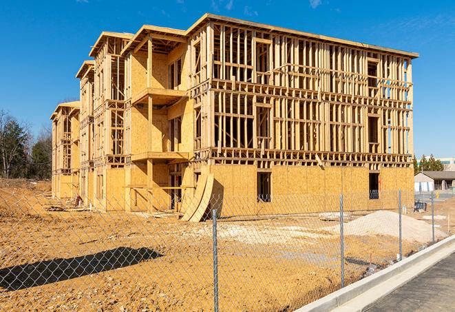 a close-up of temporary chain link fences enclosing a job site, signaling progress in the project's development in Compton, CA